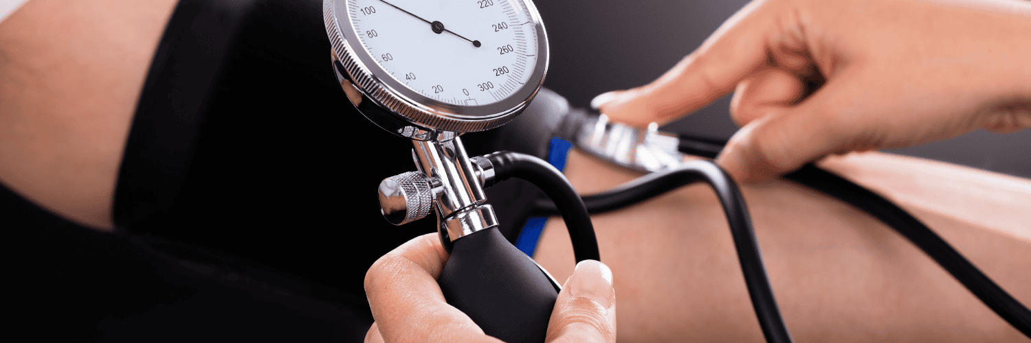 Amlodipine vs Atacand Comparison - Amlodipine Atacand - Manual blood pressure cuff and gauge being used on a patient's arm by a professional.