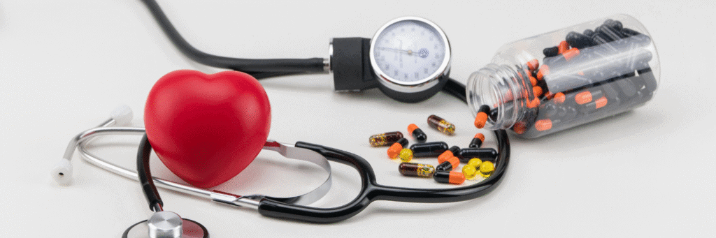 Atacand vs Losartan - A Comparison for Hypertension - Atacand and Losartan - Black and orange capsules spilled from a bottle near a red heart and medical stethoscope.