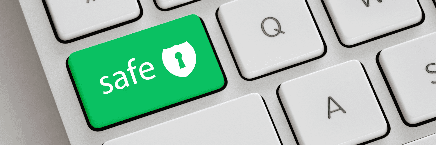 Questions to Ask Before You Order Medication Online - Online Pharmacy Security - Close-up of a white computer keyboard with a green "safe" button featuring a shield and keyhole icon.